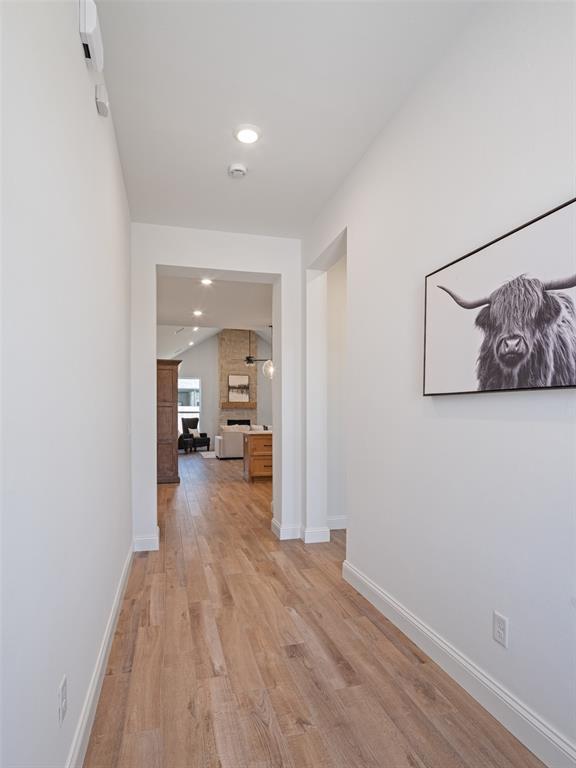 7909 NW 162nd St, Edmond, OK 73013 - hallway with light wood-style flooring, baseboards, and recessed lighting