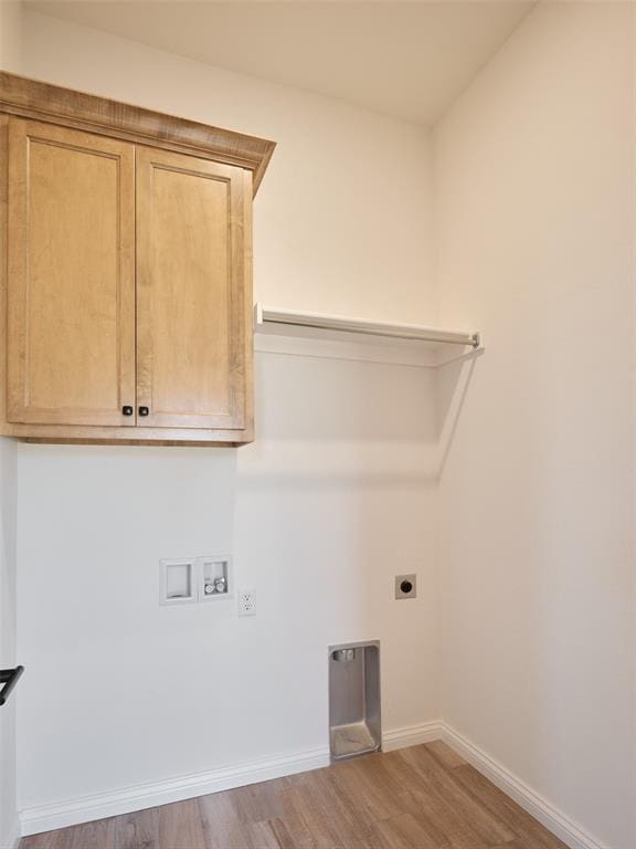7909 NW 162nd St, Edmond, OK 73013 - laundry area with hookup for an electric dryer, wood finished floors, hookup for a washing machine, baseboards, and cabinet space