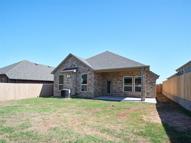 7909 NW 162nd St, Edmond, OK 73013 - back of house featuring brick siding, a patio, central AC, and roof with shingles