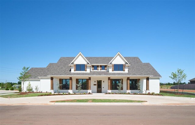 7909 NW 162nd St, Edmond, OK 73013 - modern farmhouse style home with a porch and roof with shingles