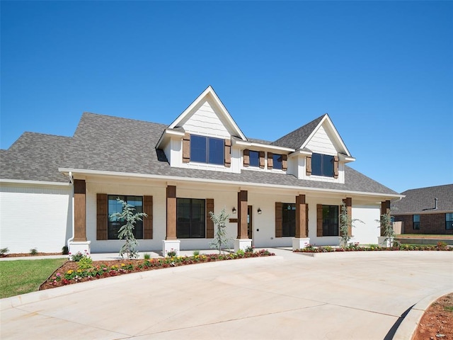 7909 NW 162nd St, Edmond, OK 73013 - modern inspired farmhouse featuring a porch, a shingled roof, and concrete driveway