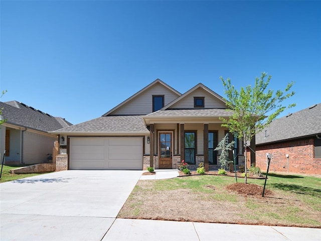 7909 NW 162nd St, Edmond, OK 73013 - view of front of property featuring a porch, an attached garage, concrete driveway, brick siding, and a front lawn