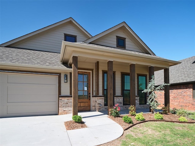 7909 NW 162nd St, Edmond, OK 73013 - view of front facade featuring an attached garage, a porch, a shingled roof, and driveway