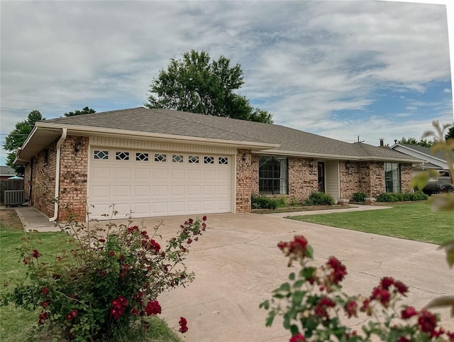 715 N Max, Hinton, OK 73047 - single story home featuring an attached garage, concrete driveway, brick siding, a front lawn, and central air condition unit