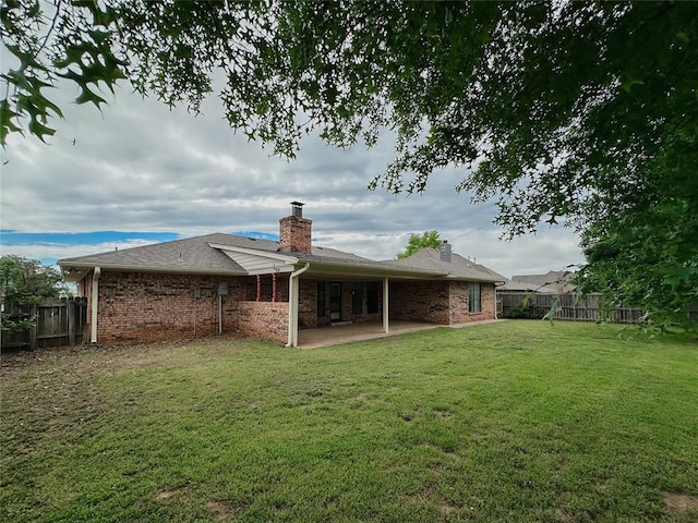715 N Max, Hinton, OK 73047 - back of property featuring a chimney, a patio, and brick siding