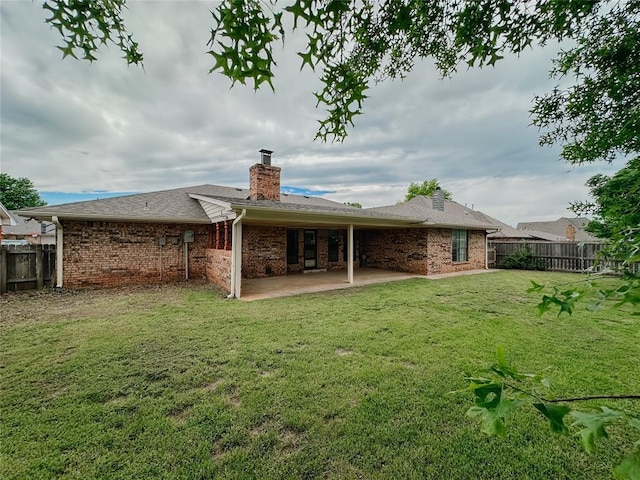 715 N Max, Hinton, OK 73047 - rear view of property featuring a patio, a chimney, and brick siding