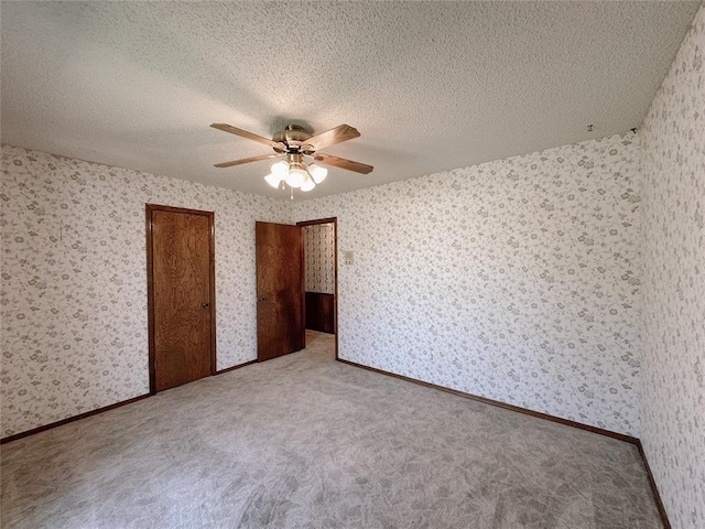 715 N Max, Hinton, OK 73047 - unfurnished bedroom featuring wallpapered walls, carpet floors, a ceiling fan, and a textured ceiling