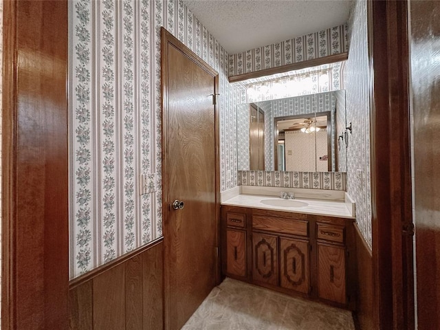 715 N Max, Hinton, OK 73047 - bathroom featuring wallpapered walls, vanity, a textured ceiling, and a ceiling fan