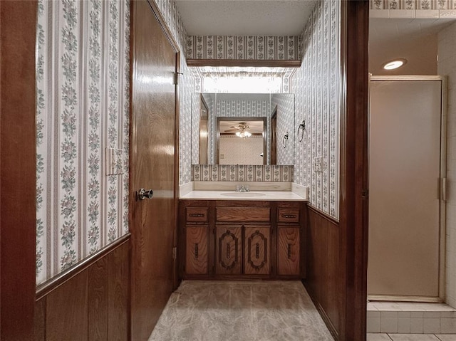 715 N Max, Hinton, OK 73047 - bathroom with wallpapered walls, vanity, wainscoting, wood walls, and tile patterned floors