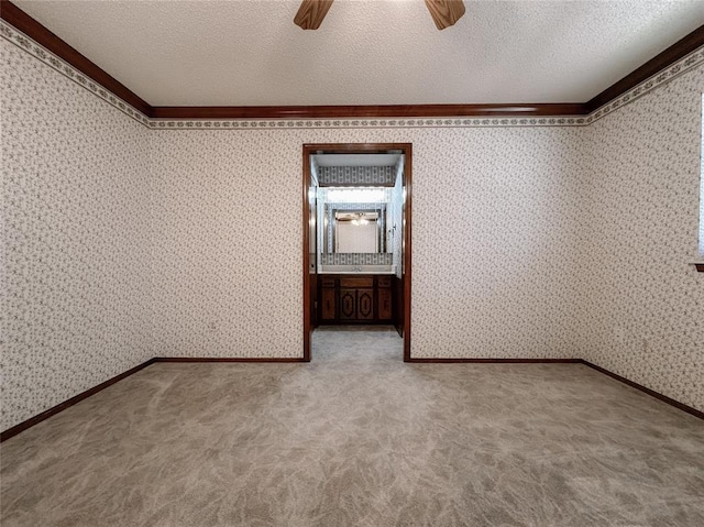 715 N Max, Hinton, OK 73047 - spare room featuring a ceiling fan, ornamental molding, carpet floors, and a textured ceiling