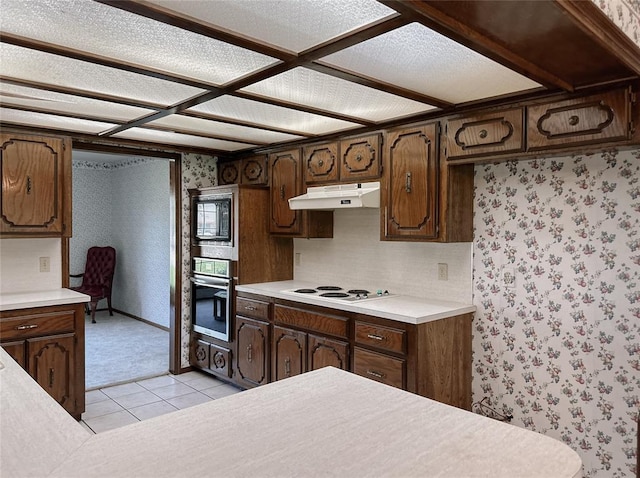 715 N Max, Hinton, OK 73047 - kitchen featuring oven, under cabinet range hood, white electric cooktop, light countertops, and wallpapered walls