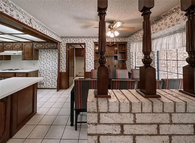 715 N Max, Hinton, OK 73047 - dining room with wallpapered walls, a ceiling fan, a textured ceiling, and light tile patterned floors