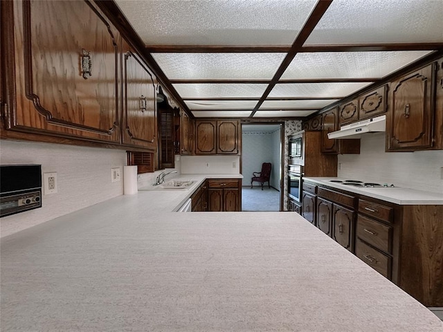 715 N Max, Hinton, OK 73047 - kitchen featuring under cabinet range hood, appliances with stainless steel finishes, a sink, light countertops, and dark brown cabinetry