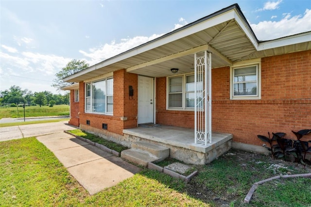3831 NW Bell Ave, Lawton, OK 73505 - property entrance with brick siding, crawl space, and covered porch