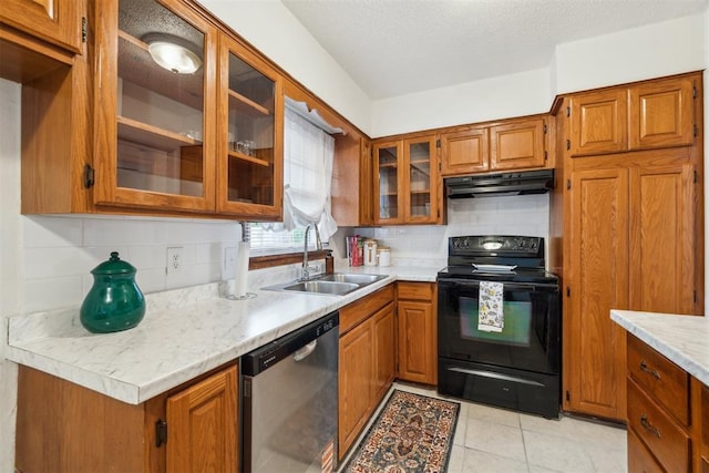3831 NW Bell Ave, Lawton, OK 73505 - kitchen featuring dishwasher, black electric range oven, a sink, under cabinet range hood, and brown cabinetry