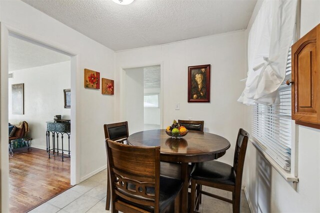 3831 NW Bell Ave, Lawton, OK 73505 - dining space featuring a textured ceiling and light tile patterned floors