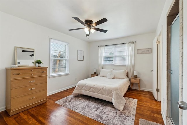 3831 NW Bell Ave, Lawton, OK 73505 - bedroom with multiple windows, dark wood-style flooring, and baseboards
