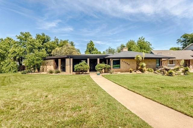 11100 Willow Grove Rd, Oklahoma City, OK 73120 - view of front of home with a front lawn and a chimney