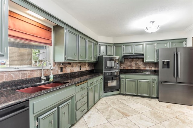 11100 Willow Grove Rd, Oklahoma City, OK 73120 - kitchen featuring green cabinets, black appliances, tasteful backsplash, under cabinet range hood, and dark stone countertops