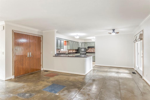 11100 Willow Grove Rd, Oklahoma City, OK 73120 - kitchen with concrete floors, tasteful backsplash, a peninsula, ornamental molding, and dark countertops