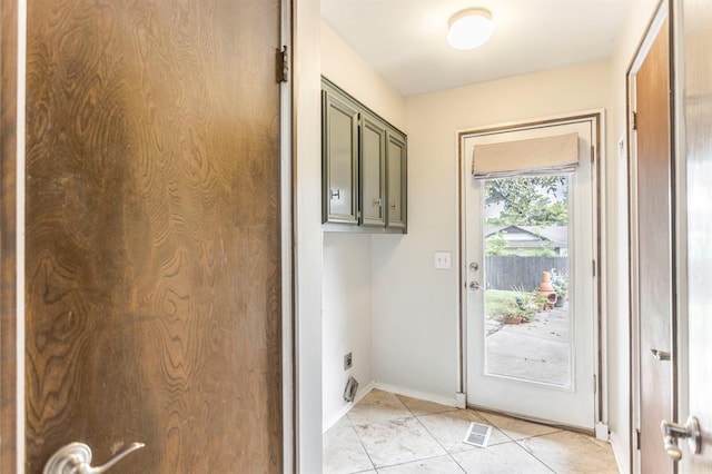 11100 Willow Grove Rd, Oklahoma City, OK 73120 - laundry room with cabinet space, light tile patterned floors, and electric dryer hookup