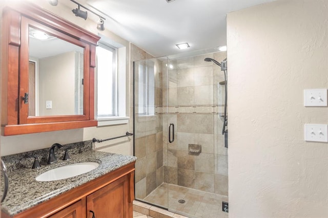 11100 Willow Grove Rd, Oklahoma City, OK 73120 - bathroom featuring vanity, a stall shower, and a textured wall