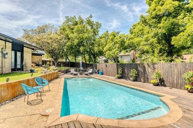 11100 Willow Grove Rd, Oklahoma City, OK 73120 - view of swimming pool featuring a fenced backyard, a wooden deck, and a patio