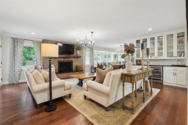 1201 Westchester Dr, Oklahoma City, OK 73114 - living area with beverage cooler, a chandelier, a large fireplace, plenty of natural light, and ornamental molding
