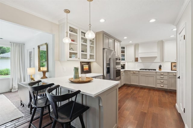 1201 Westchester Dr, Oklahoma City, OK 73114 - kitchen featuring appliances with stainless steel finishes, a peninsula, glass insert cabinets, light countertops, and a kitchen breakfast bar