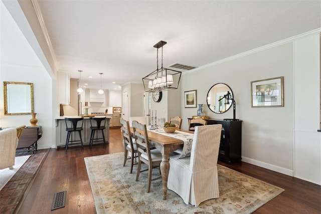 1201 Westchester Dr, Oklahoma City, OK 73114 - dining area featuring baseboards, dark wood-type flooring, ornamental molding, recessed lighting, and a chandelier