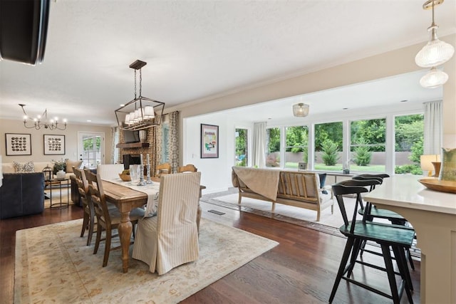 1201 Westchester Dr, Oklahoma City, OK 73114 - dining space with dark wood-style flooring, a brick fireplace, and ornamental molding