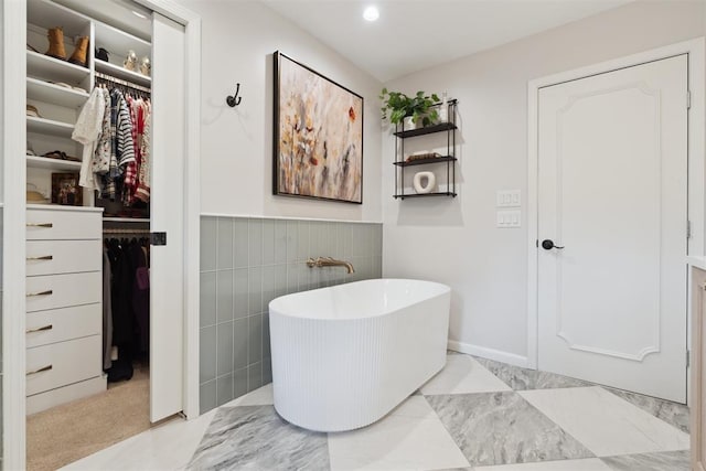1201 Westchester Dr, Oklahoma City, OK 73114 - bathroom with a freestanding bath, a walk in closet, a wainscoted wall, and recessed lighting