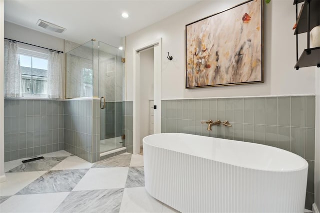1201 Westchester Dr, Oklahoma City, OK 73114 - full bath with tile walls, a stall shower, a soaking tub, and recessed lighting