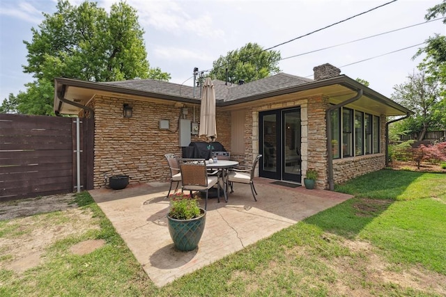 1201 Westchester Dr, Oklahoma City, OK 73114 - rear view of property featuring stone siding, a patio, a chimney, roof with shingles, and french doors
