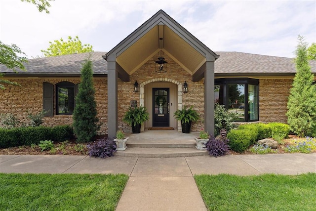 1201 Westchester Dr, Oklahoma City, OK 73114 - entrance to property with a shingled roof, stone siding, and a porch