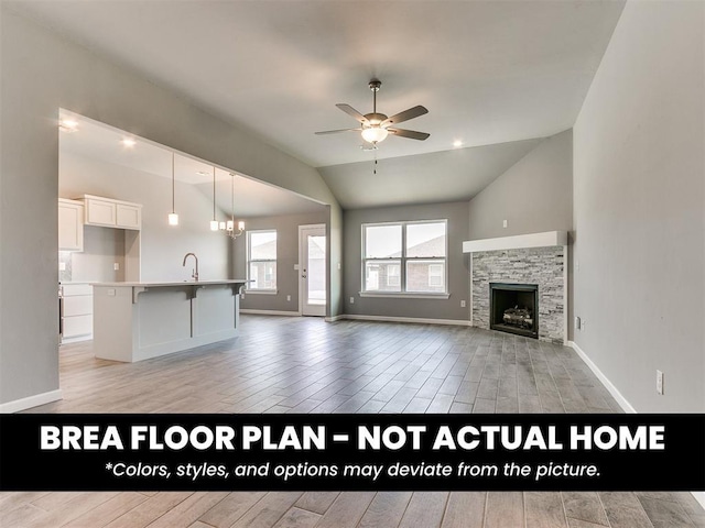 1100 Redwood Creek Dr, Yukon, OK 73099 - unfurnished living room featuring vaulted ceiling, light wood-type flooring, ceiling fan, a sink, and a chandelier