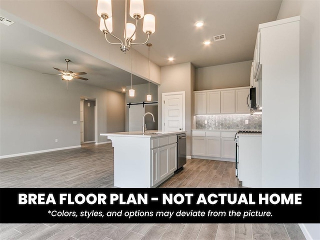 1100 Redwood Creek Dr, Yukon, OK 73099 - kitchen featuring light wood-style flooring, stainless steel appliances, a center island with sink, ceiling fan, and recessed lighting