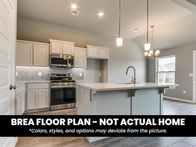 1100 Redwood Creek Dr, Yukon, OK 73099 - kitchen with appliances with stainless steel finishes, a sink, backsplash, light countertops, and lofted ceiling