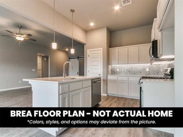 1100 Redwood Creek Dr, Yukon, OK 73099 - kitchen featuring appliances with stainless steel finishes, a sink, a ceiling fan, a center island with sink, and white cabinets