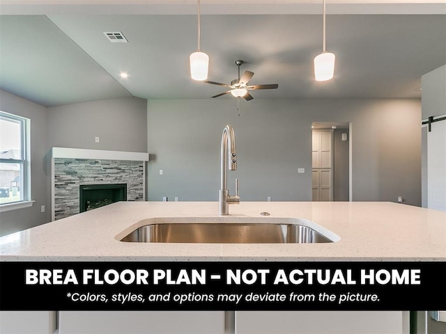 1100 Redwood Creek Dr, Yukon, OK 73099 - kitchen featuring a sink, open floor plan, a ceiling fan, decorative light fixtures, and a barn door