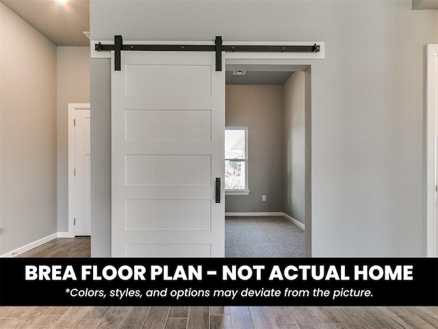 1100 Redwood Creek Dr, Yukon, OK 73099 - spare room featuring a barn door, baseboards, and wood finished floors