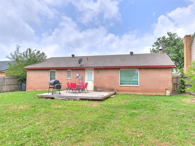 216 N English Dr, Moore, OK 73160 - back of property with brick siding, a deck, and a shingled roof