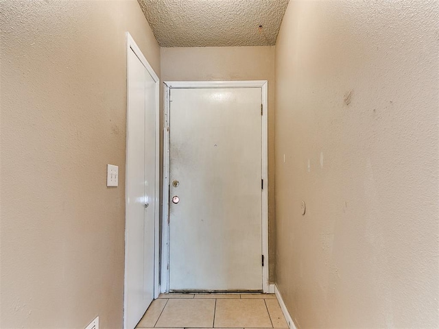 216 N English Dr, Moore, OK 73160 - doorway to outside with light tile patterned floors and a textured ceiling