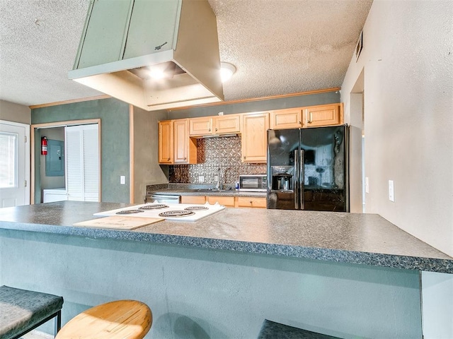 216 N English Dr, Moore, OK 73160 - kitchen featuring black refrigerator with ice dispenser, a textured ceiling, dark countertops, light brown cabinets, and white stovetop