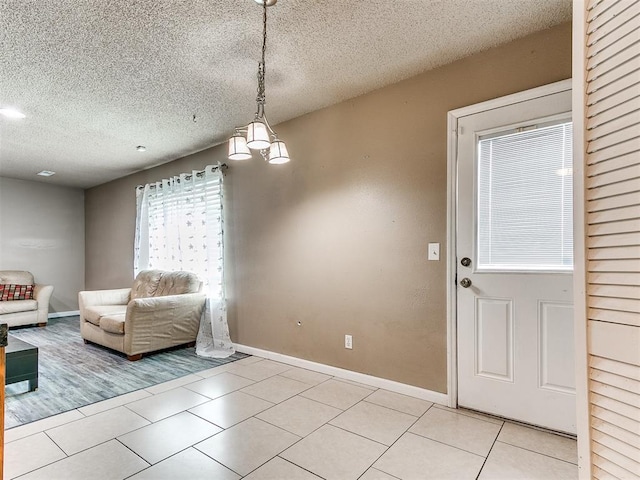 216 N English Dr, Moore, OK 73160 - living area with light tile patterned floors, baseboards, and a textured ceiling