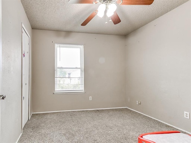 216 N English Dr, Moore, OK 73160 - unfurnished bedroom with a textured ceiling, carpet floors, ceiling fan, and baseboards