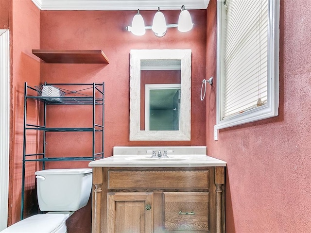 216 N English Dr, Moore, OK 73160 - bathroom featuring healthy amount of natural light, toilet, a textured wall, vanity, and ornamental molding