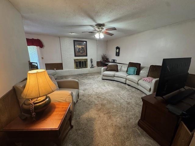 2904 N Shannon Ave, Bethany, OK 73008 - carpeted living room featuring a ceiling fan, a textured ceiling, and a fireplace