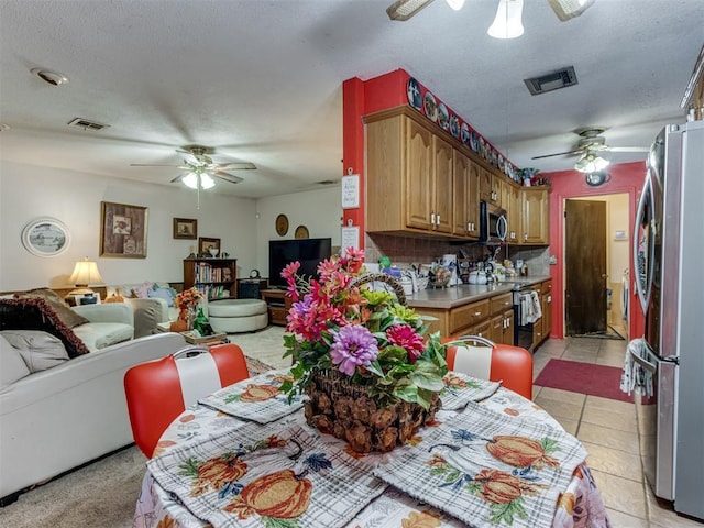 2904 N Shannon Ave, Bethany, OK 73008 - dining space with ceiling fan, a textured ceiling, and light tile patterned floors
