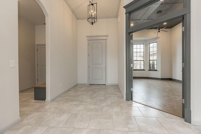 9120 SW 34th St, Oklahoma City, OK 73179 - entrance foyer featuring arched walkways, baseboards, ceiling fan, and crown molding